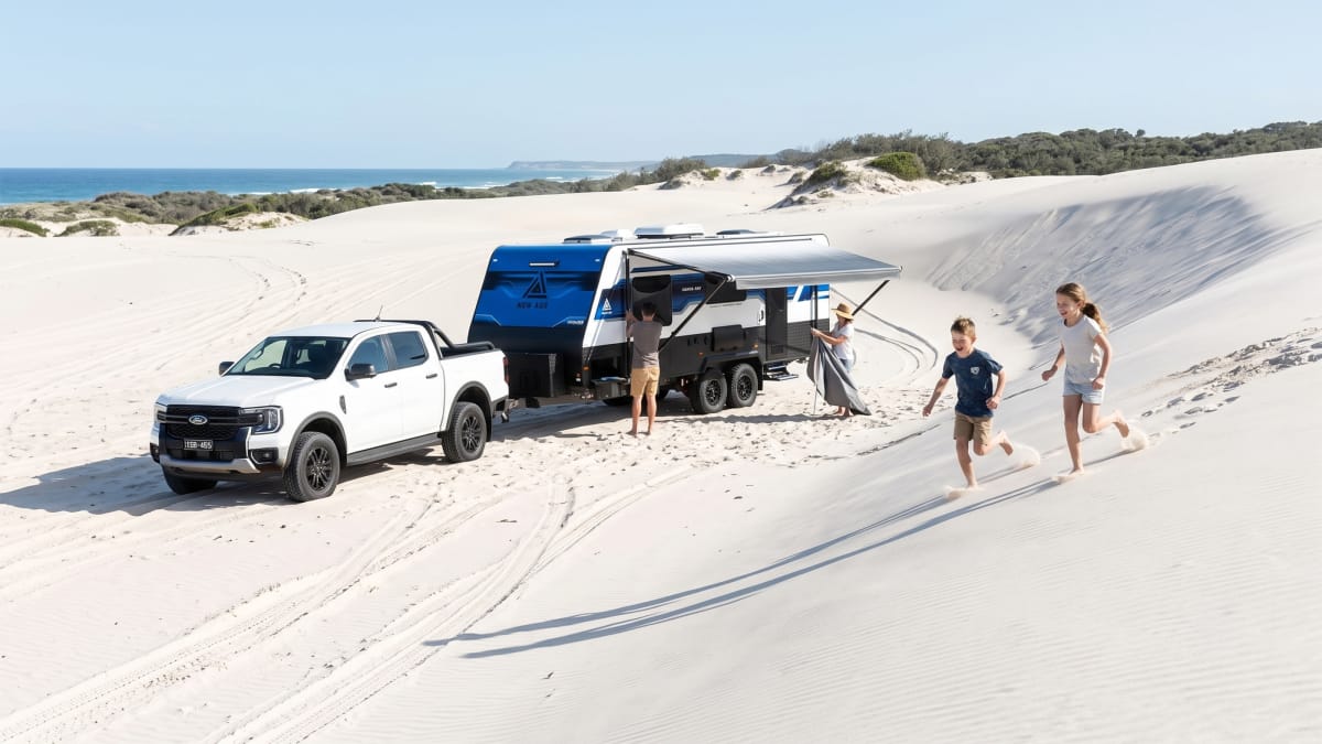 A New Age full off-road caravan travelling through remote Australia